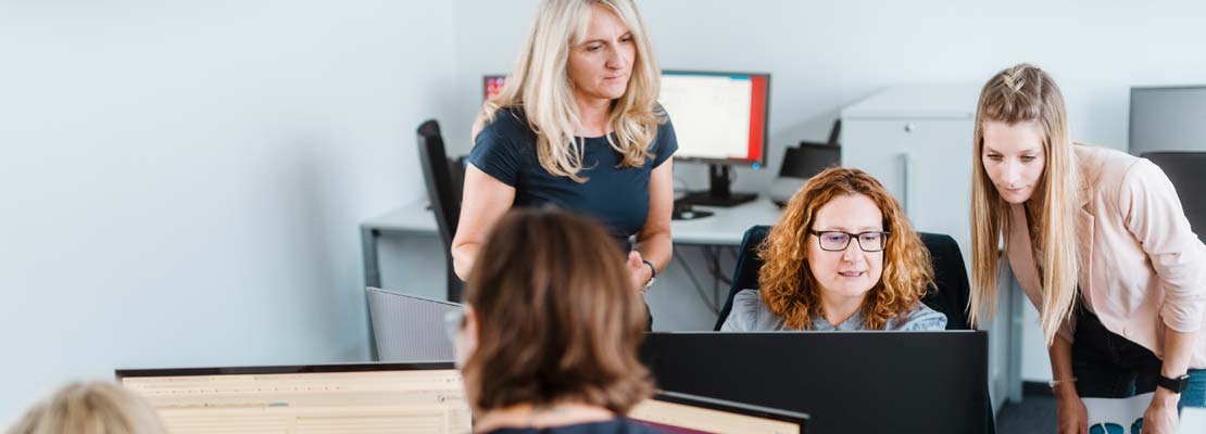 Two employees working with computers